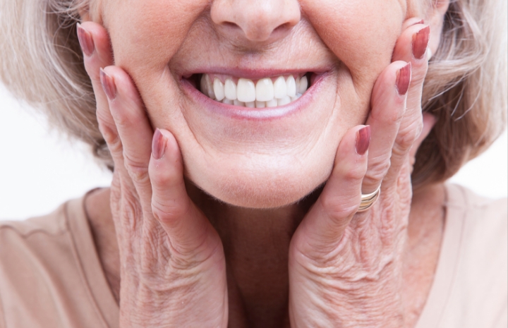 Closeup of smiling dental patient enjoying the benefits of dentures