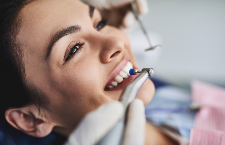 Woman receiving dental checkup and teeth cleaning