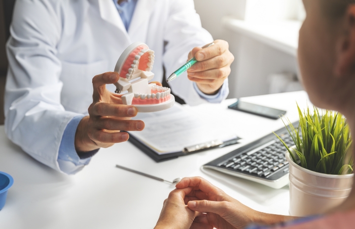 Dentist and dental patient discussing dentistry treatment