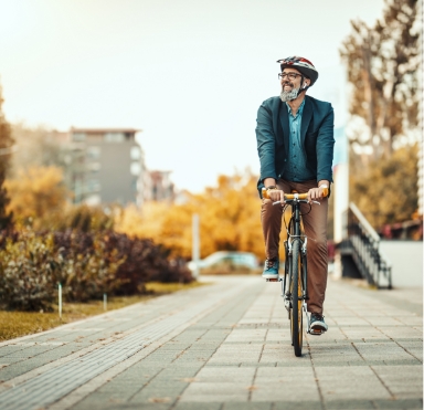 Smiling man on bike with dental implants