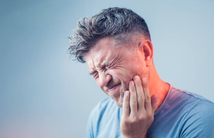 Man in pain before tooth replacement
