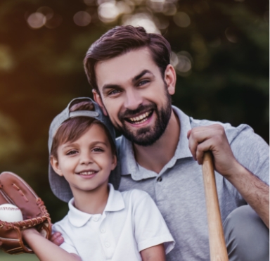 Father and child smiling together after tooth replacement with dental implants