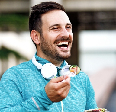 Laughing man enjoying the day to day benefits of dental implants