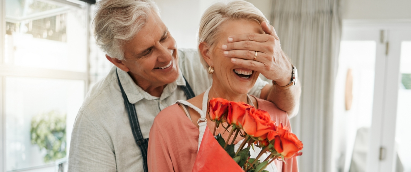 Man and woman with dentures laughing together