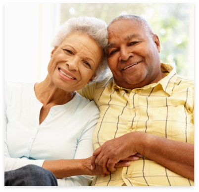 Man and woman with dentures smiling together