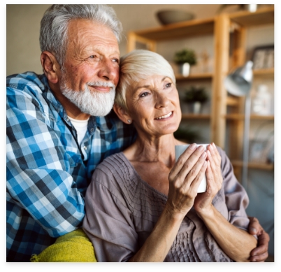 Older couple with implant dentures smiling together