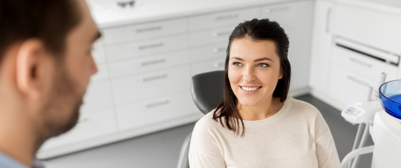 Woman smiling at her emergency dentist