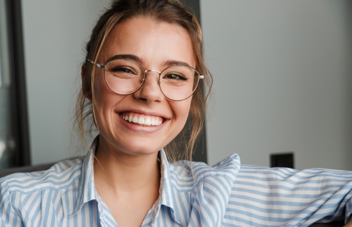 Woman sharing flawless smile thanks to metal free dental restoration