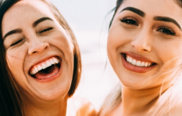 Two women smiling after cosmetic dentistry