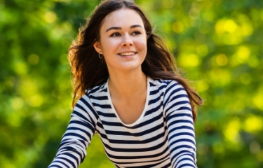 Woman smiling after replacing missing teeth