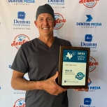 Dentist holding a plaque