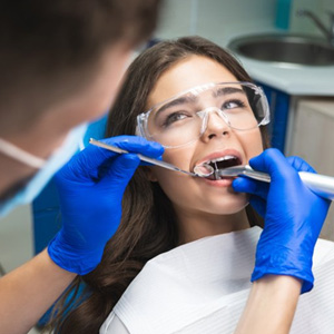 Dentist cleaning a patient’s teeth