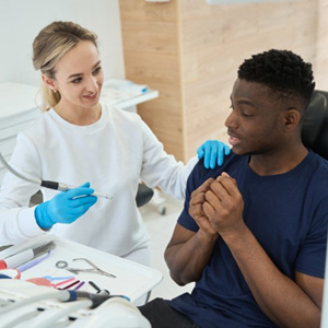 Nervous patient being reassured by dentist