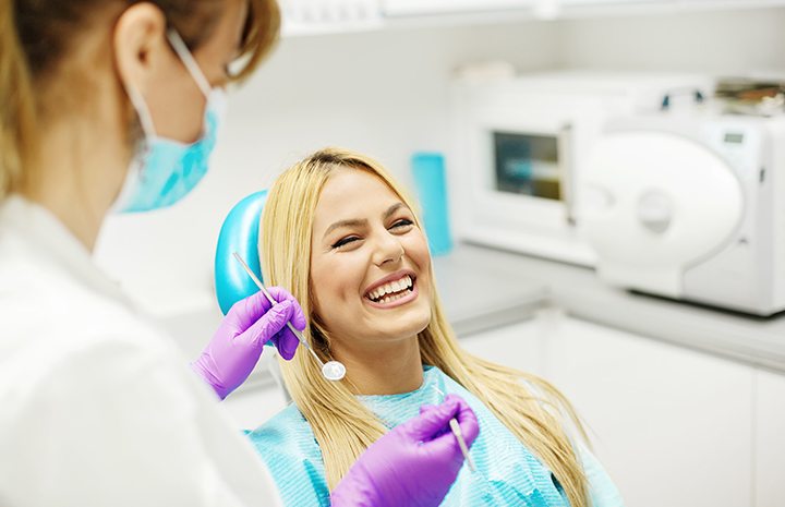 Laughing female patient in dentist’s chair