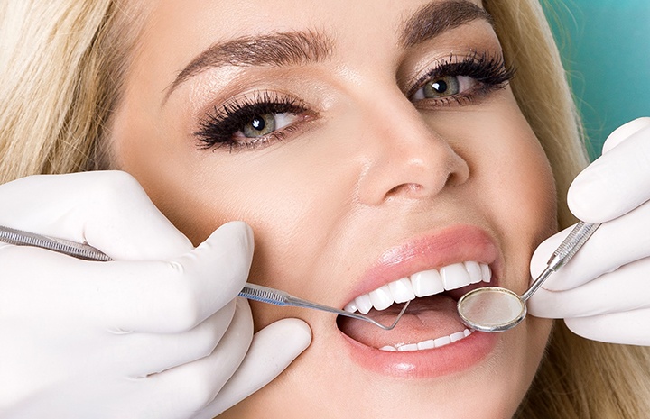 Dental instruments near woman’s mouth