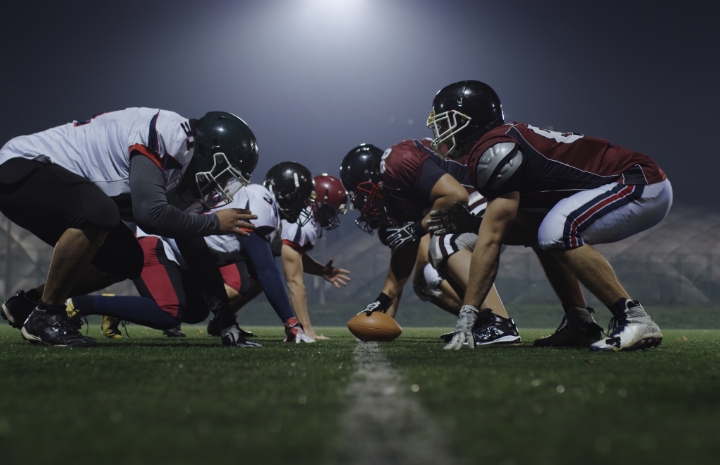 Teens with athletic mouthguards playing football