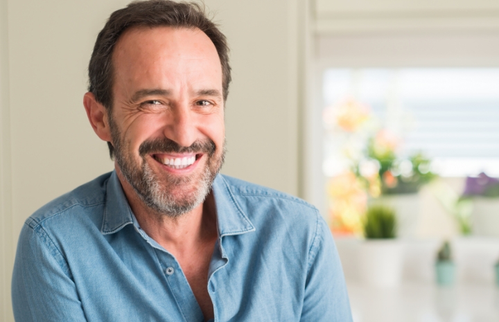 Man smiling after repairing tooth decay