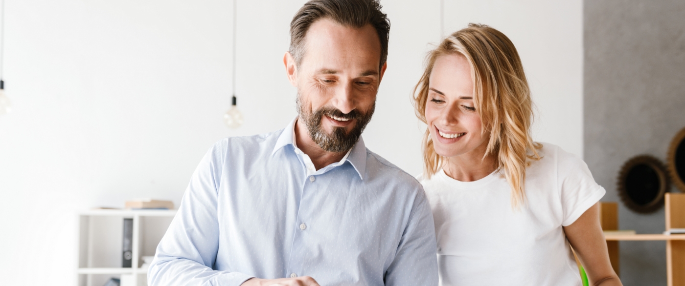 Man and woman smiling after restorative dentistry