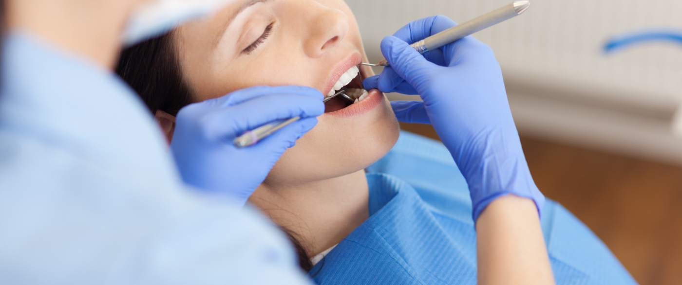 Woman receiving dental treatment under sedation dentistry