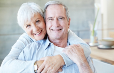 Man and woman smiling after cosmetic dentistry