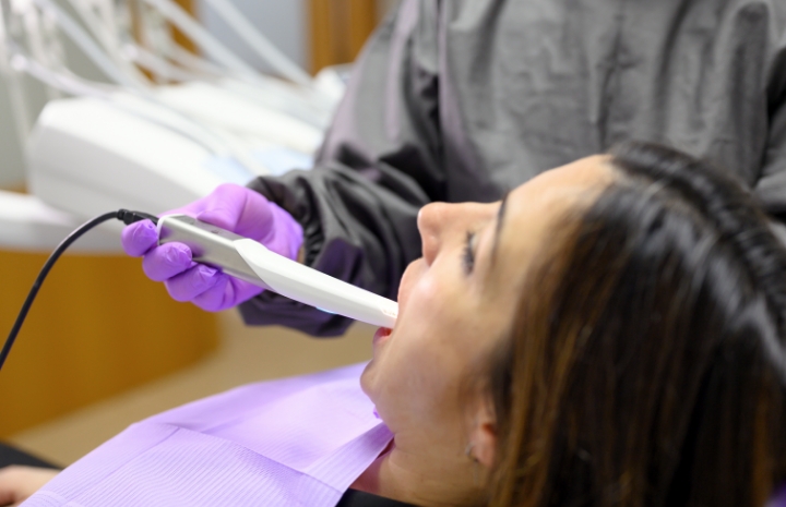 Dentist using intraoral camera to capture smile images