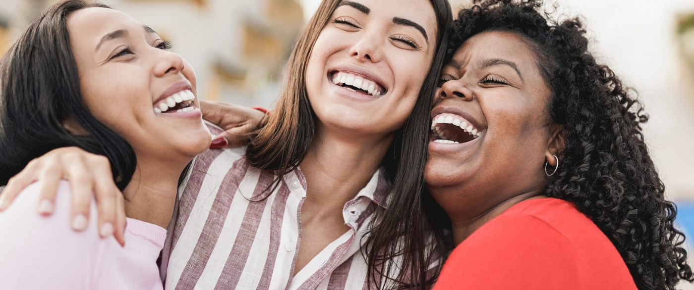 Friends sharing bright smiles after teeth whitening