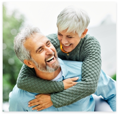 Man and woman with veneers smiling