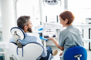 a man visiting and sharing information with his dentist at a checkup