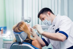 Dentist examining a woman’s mouth