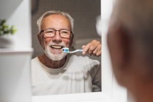 Senior man about to brush his teeth